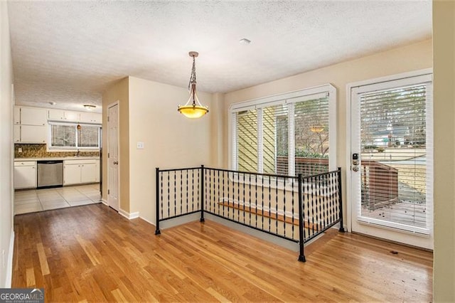 interior space with sink, a textured ceiling, and light hardwood / wood-style flooring