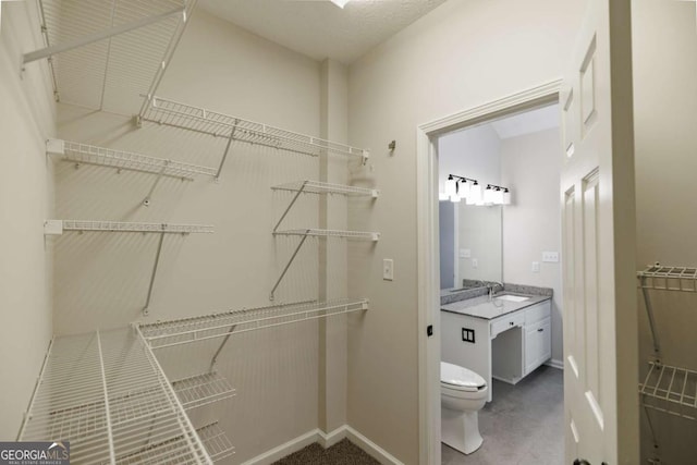 walk in closet featuring sink