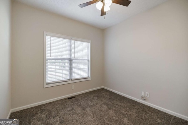 carpeted empty room featuring ceiling fan