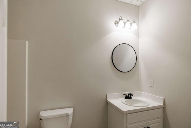 bathroom featuring vanity and toilet