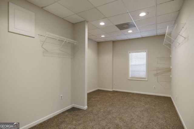 walk in closet with carpet floors and a paneled ceiling