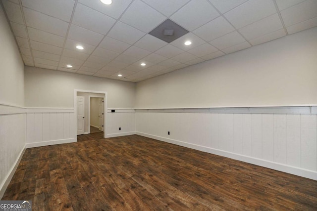 unfurnished room featuring dark hardwood / wood-style floors and a paneled ceiling