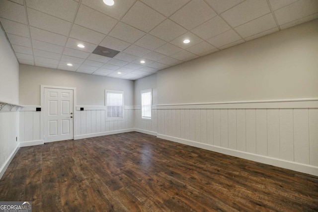 empty room featuring dark hardwood / wood-style floors and a drop ceiling