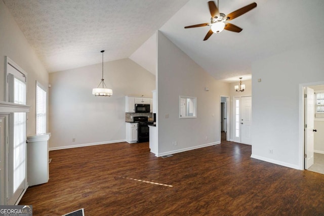 unfurnished living room featuring dark wood-type flooring, high vaulted ceiling, ceiling fan with notable chandelier, and a textured ceiling