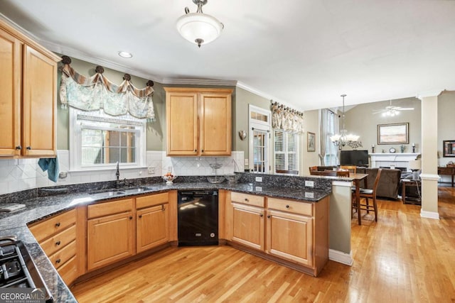 kitchen with pendant lighting, dishwasher, sink, kitchen peninsula, and light hardwood / wood-style flooring