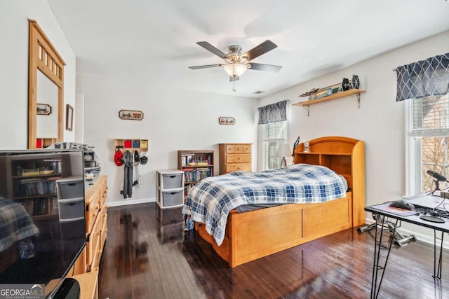 bedroom with dark wood-type flooring and ceiling fan