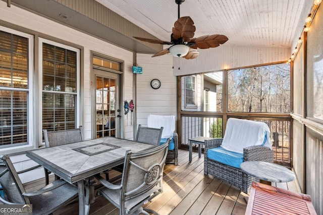 sunroom / solarium with lofted ceiling, wooden ceiling, and ceiling fan