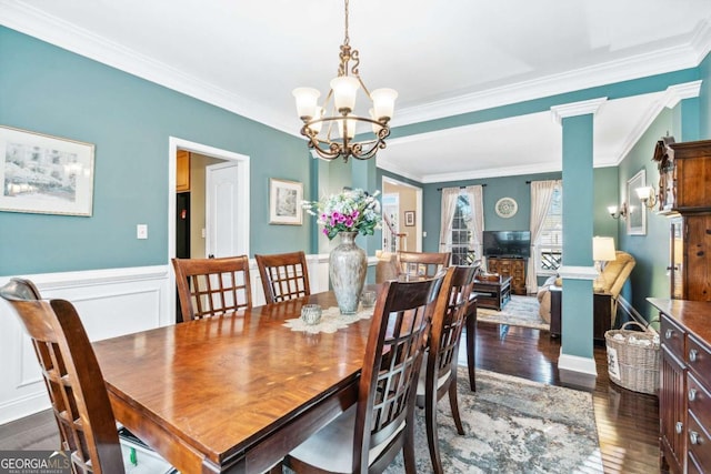 dining area with crown molding, dark hardwood / wood-style floors, and a chandelier