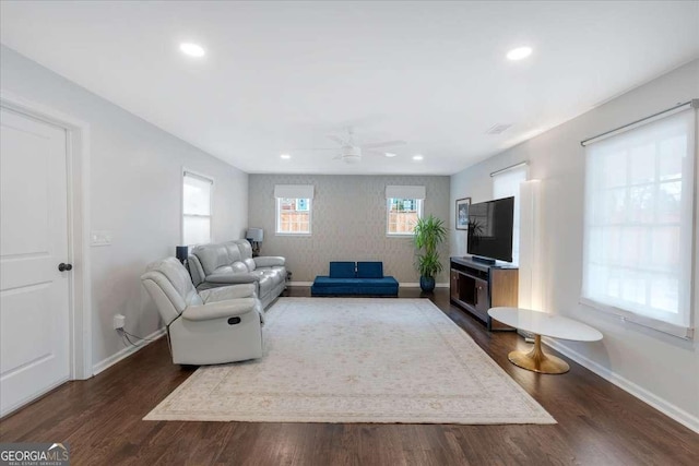 living room featuring dark hardwood / wood-style floors and ceiling fan