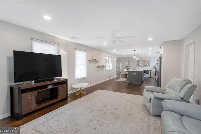 living room with ceiling fan and dark hardwood / wood-style floors