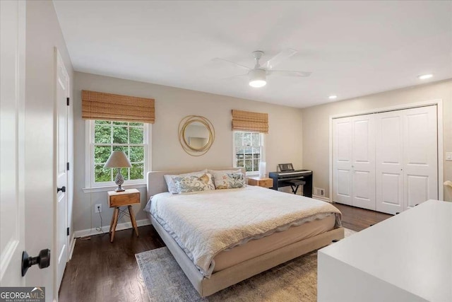 bedroom featuring dark hardwood / wood-style flooring, a closet, and ceiling fan