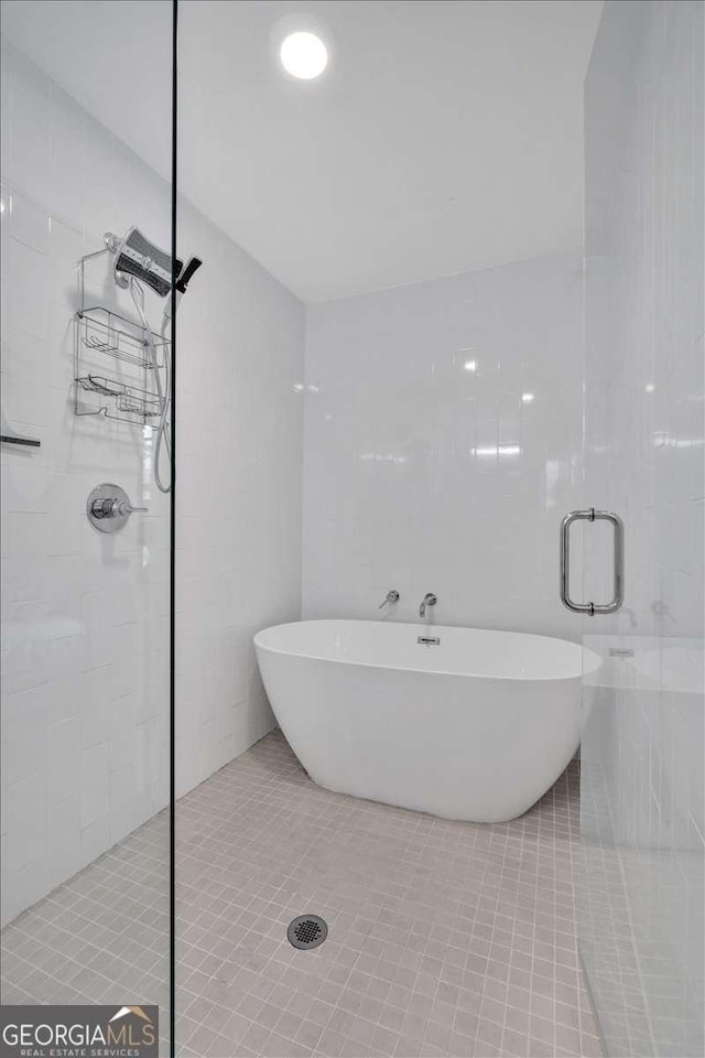 bathroom with tile patterned floors and plus walk in shower