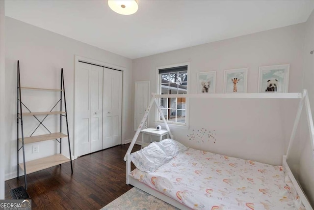 bedroom featuring dark wood-type flooring and a closet