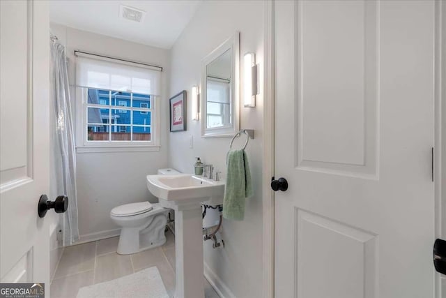 bathroom with tile patterned floors and toilet