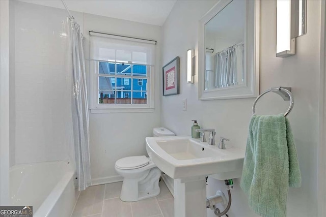 bathroom with shower / tub combo with curtain, tile patterned floors, and toilet