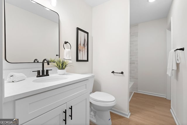 full bathroom featuring vanity, wood-type flooring, shower / bathtub combination, and toilet