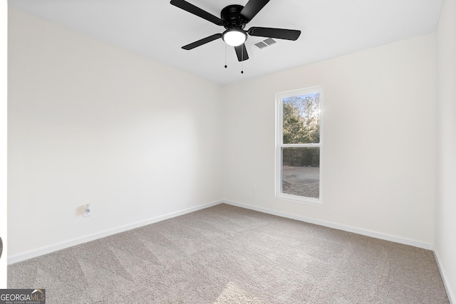 unfurnished room with carpet and ceiling fan