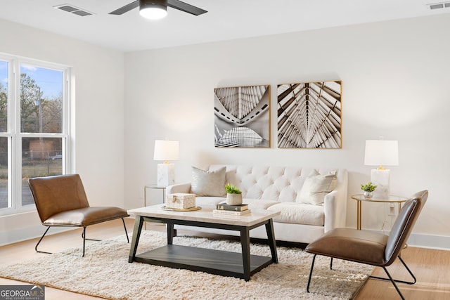 living room featuring hardwood / wood-style flooring and ceiling fan