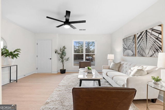 living room featuring ceiling fan and light hardwood / wood-style floors