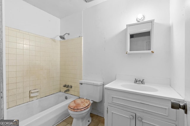 full bathroom featuring vanity, toilet, tiled shower / bath combo, and tile patterned flooring