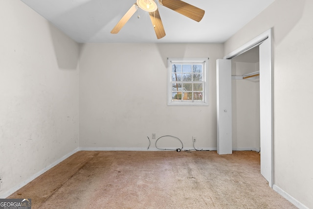 unfurnished bedroom with light colored carpet, a closet, and ceiling fan