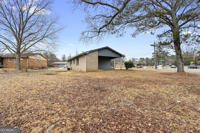 view of side of home with a carport