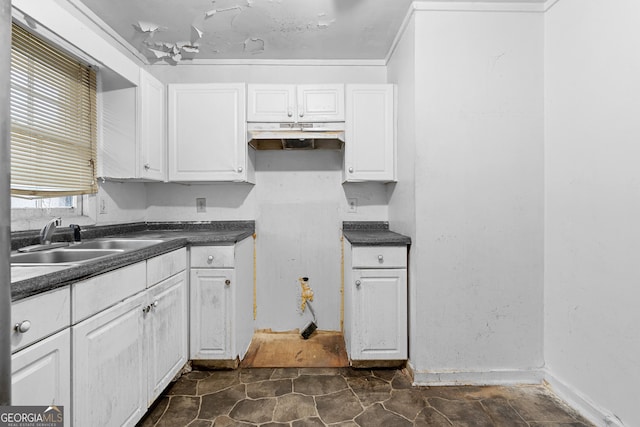 kitchen featuring sink and white cabinets