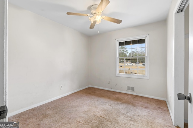 spare room with light carpet and ceiling fan