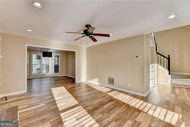 unfurnished living room with ceiling fan and light hardwood / wood-style flooring