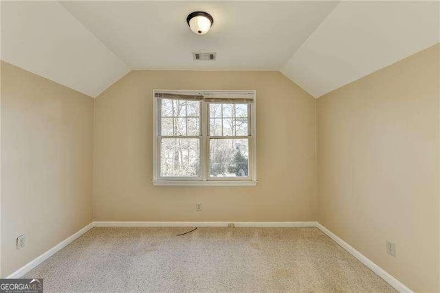 bonus room featuring lofted ceiling and light colored carpet