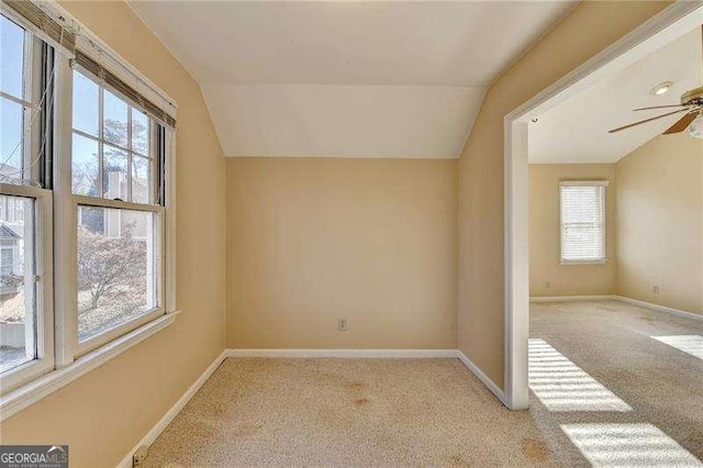 additional living space with vaulted ceiling, light carpet, and ceiling fan