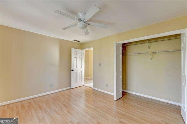 unfurnished bedroom with ceiling fan, a closet, and light hardwood / wood-style flooring