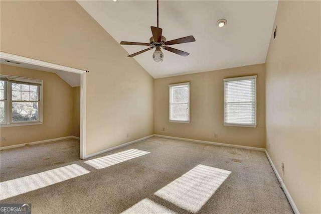 spare room with light carpet, plenty of natural light, and ceiling fan