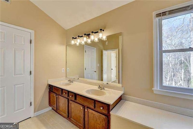 bathroom with vanity and vaulted ceiling