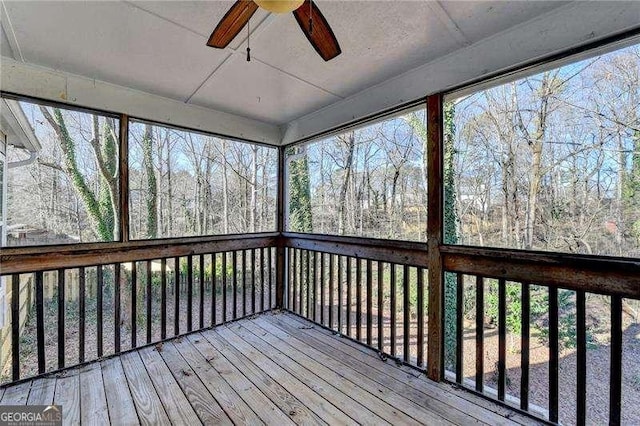 unfurnished sunroom featuring plenty of natural light and ceiling fan