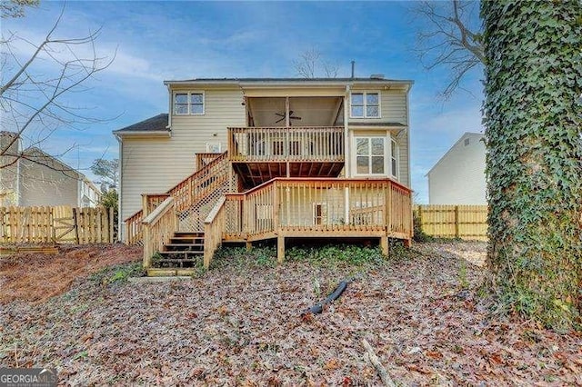 back of property featuring a deck and ceiling fan