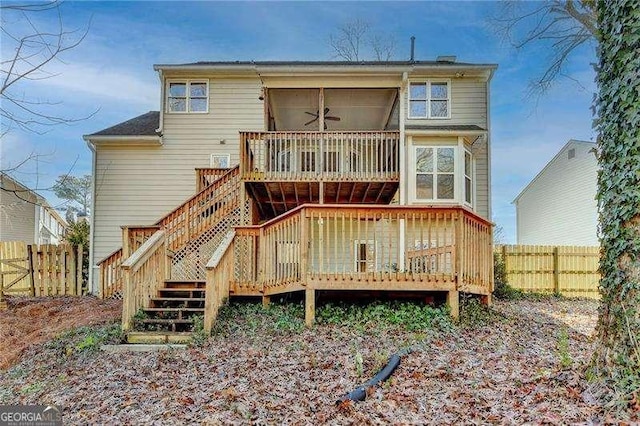 rear view of house with ceiling fan and a deck