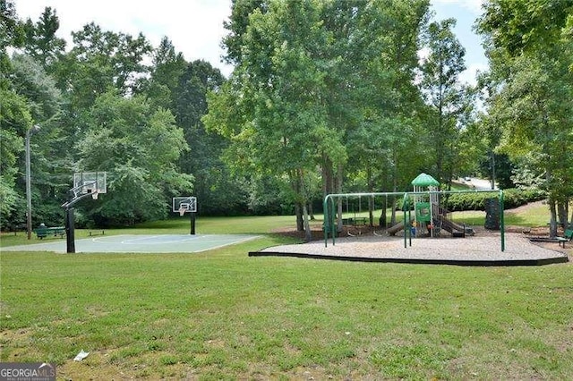 view of playground featuring basketball court and a lawn