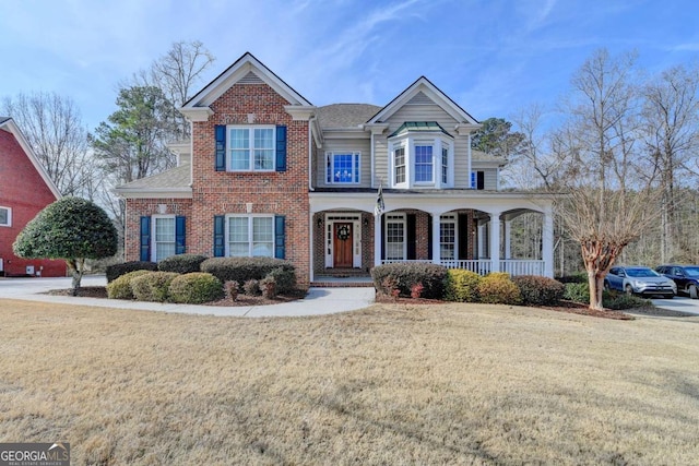 view of front facade featuring a porch and a front yard