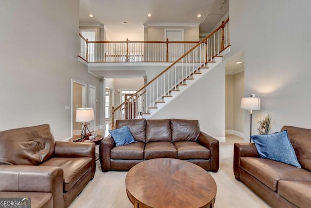 carpeted living room featuring crown molding and a towering ceiling