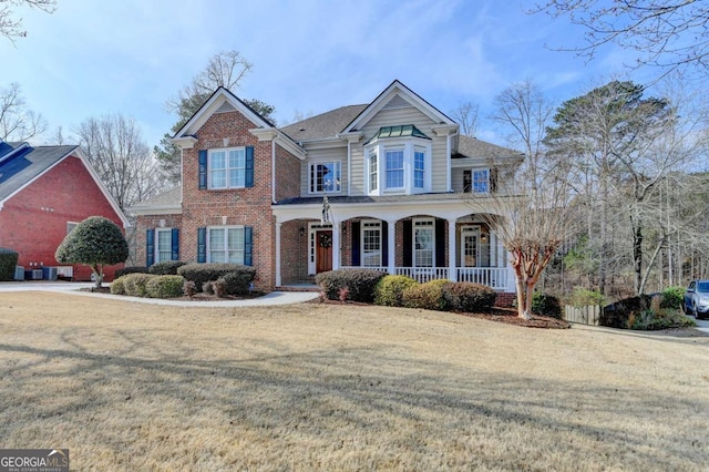 view of front of house featuring a porch and a front lawn