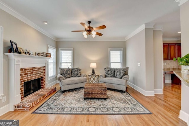 living room featuring hardwood / wood-style flooring, crown molding, and a healthy amount of sunlight