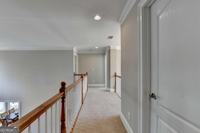 corridor featuring ornamental molding and light carpet