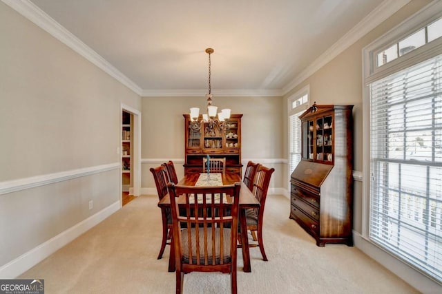 carpeted dining area with ornamental molding and a chandelier