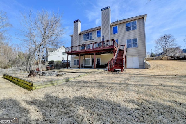 rear view of house with a yard, a patio area, and a deck