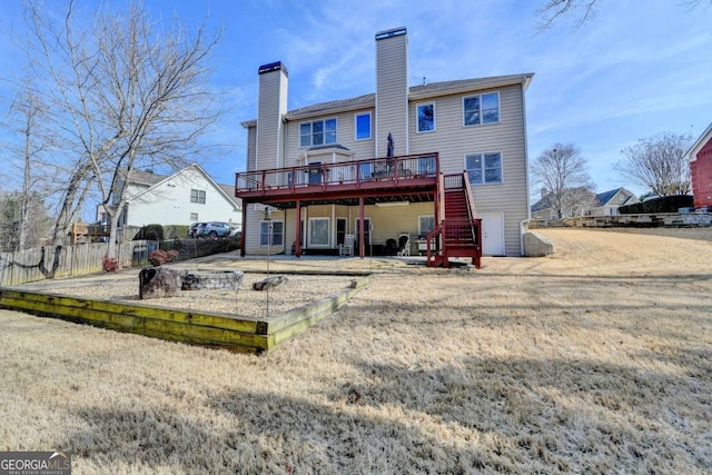 rear view of house with a patio, a deck, and a lawn