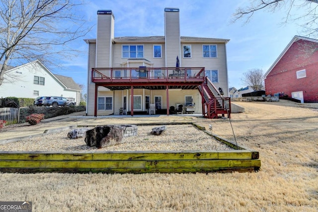 rear view of house with a patio and a deck