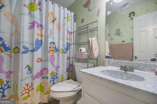 bathroom with vanity, a shower with curtain, and toilet