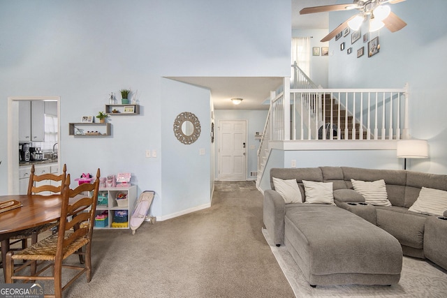 living room featuring ceiling fan and carpet