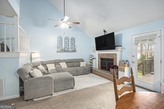 living room with a brick fireplace, carpet floors, high vaulted ceiling, and ceiling fan